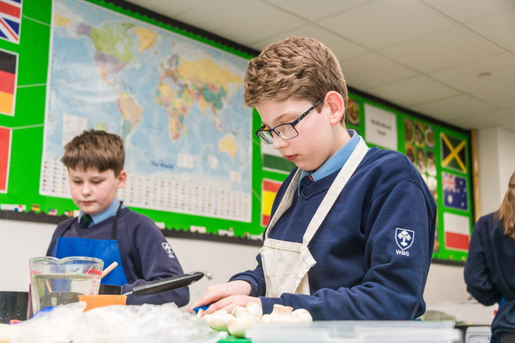 Two male students using equipment and facilities in the Food Tech room